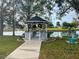 White gazebo provides a calm place to relax while looking out at the lake and water fountain at 6665 Keystone Ct, North Port, FL 34287