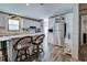 Bright kitchen with white cabinets, stainless steel refrigerator, and island seating at 6665 Keystone Ct, North Port, FL 34287