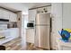 Bright kitchen with stainless steel refrigerator, white cabinets, and wood-look floors at 6665 Keystone Ct, North Port, FL 34287
