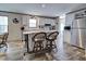 Bright kitchen with white cabinets, island with seating, and stainless steel appliances at 6665 Keystone Ct, North Port, FL 34287
