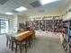 A community library featuring floor-to-ceiling bookshelves, a large wooden table, and an inviting reading space at 6665 Keystone Ct, North Port, FL 34287