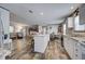 Open-concept living room and kitchen with wood-look floors and natural light at 6665 Keystone Ct, North Port, FL 34287