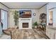 This living room features a cozy fireplace, stylish decorations, and ample room for relaxation and entertaining at 6665 Keystone Ct, North Port, FL 34287