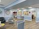 Brightly lit clubhouse lobby is warmly decorated and features comfortable chairs and tables at 6665 Keystone Ct, North Port, FL 34287