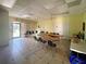 Versatile meeting room with tables, chairs, and natural light, ideal for gatherings and events at 6665 Keystone Ct, North Port, FL 34287