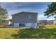 Rear view of home with wooden stairs leading to the back door and well maintained landscaping at 6665 Keystone Ct, North Port, FL 34287