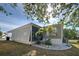 Rear view of screened-in lanai area with a well maintained yard at 6665 Keystone Ct, North Port, FL 34287