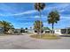 Street view of gray home featuring well-maintained landscaping and a covered carport in a lovely community at 6665 Keystone Ct, North Port, FL 34287