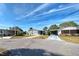 Street view of gray home featuring well-maintained landscaping and a covered carport in a lovely community at 6665 Keystone Ct, North Port, FL 34287