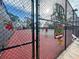 Tennis courts featuring a secure fence with festive holiday decorations at 6665 Keystone Ct, North Port, FL 34287