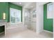 Bright bathroom featuring a soaking tub and a walk-in shower with glass surround at 707 Petrel Way, Venice, FL 34285