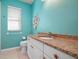 Bathroom with granite countertop, decorative seashell art and colorful wall at 707 Petrel Way, Venice, FL 34285