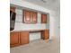 View of built-in desk with cabinets, drawers, and glass shelving in a bedroom at 707 Petrel Way, Venice, FL 34285