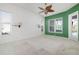 Bedroom features carpet, a ceiling fan, and three windows to provide an open and bright space at 707 Petrel Way, Venice, FL 34285