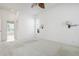 Well-lit bedroom featuring a ceiling fan and stylish sconce lighting at 707 Petrel Way, Venice, FL 34285