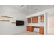 Bedroom with TV, shelves, and a built-in desk featuring drawers and cabinets for storage at 707 Petrel Way, Venice, FL 34285