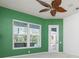 Spacious bedroom featuring a decorative ceiling fan, a window and a glass door at 707 Petrel Way, Venice, FL 34285