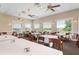 Well-lit dining room featuring tables with white tablecloths and comfortable seating with a view of the golf course at 707 Petrel Way, Venice, FL 34285