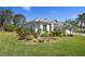 Landscaped exterior view of a single-story home with lush green lawn at 707 Petrel Way, Venice, FL 34285