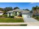 Well-maintained single-story home features a manicured lawn, front garden, and two-car garage at 707 Petrel Way, Venice, FL 34285