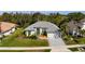 Charming single-story home with a gray tile roof, fresh landscaping, and an attached two-car garage at 707 Petrel Way, Venice, FL 34285
