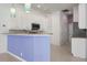 Kitchen featuring white cabinets, stainless steel appliances, and granite countertops at 707 Petrel Way, Venice, FL 34285