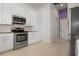 Kitchen featuring white cabinets and stainless steel appliances at 707 Petrel Way, Venice, FL 34285