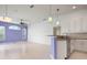 Open-concept area with a breakfast bar, tile flooring, and modern light fixtures at 707 Petrel Way, Venice, FL 34285
