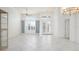 Bright and airy living room with tiled floors, custom built-ins, and decorative glass front doors at 707 Petrel Way, Venice, FL 34285