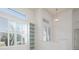 Bright living area with built-in shelving, glass front door, and high ceilings at 707 Petrel Way, Venice, FL 34285