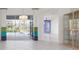 Bright living room with tile floors, stylish lighting, and sliding doors leading to the pool at 707 Petrel Way, Venice, FL 34285