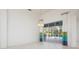 Living area with sliding glass doors, pendant lights, and colorful drapes at 707 Petrel Way, Venice, FL 34285