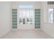 Bright room featuring custom built-in shelving and a large window with plantation shutters at 707 Petrel Way, Venice, FL 34285