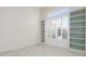 Bright living room with a custom bookcase and a large window with plantation shutters at 707 Petrel Way, Venice, FL 34285