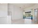 Spacious living area with sliding glass doors leading to an enclosed pool area at 707 Petrel Way, Venice, FL 34285