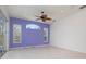 Open room with tile floor, large ceiling fan, three windows, and neutral paint, offering versatile living space at 707 Petrel Way, Venice, FL 34285