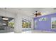 Open living space with sliding glass doors and tile flooring offers natural light with access to the outdoor pool at 707 Petrel Way, Venice, FL 34285