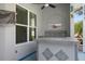 Covered patio area next to screened-in pool with an outdoor kitchen and bar seating at 707 Petrel Way, Venice, FL 34285