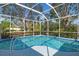 Relaxing screened-in pool surrounded by lush tropical landscaping at 707 Petrel Way, Venice, FL 34285