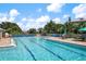 Community pool with clear blue water with seating and lounge area, covered for the off season at 707 Petrel Way, Venice, FL 34285