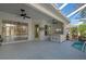 A covered patio area next to the pool features an outdoor kitchen and ceiling fans at 707 Petrel Way, Venice, FL 34285