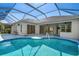 Private screened-in pool with patio, tile floor, and access to the house at 707 Petrel Way, Venice, FL 34285