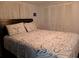 Comfortable bedroom features a floral patterned bedspread and closet with louvered doors at 718 S Green Cir, Venice, FL 34285