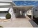 Spacious carport with a covered area and well-kept exterior of the home at 718 S Green Cir, Venice, FL 34285