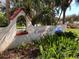Community entrance with Country Club Estates sign, landscaping, and waterfront boating community at 718 S Green Cir, Venice, FL 34285