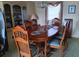 Traditional dining room with wood table, chairs, china cabinet, chandelier, and natural light at 718 S Green Cir, Venice, FL 34285