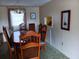 Comfortable dining room with wood table, chairs, chandelier, and natural light at 718 S Green Cir, Venice, FL 34285