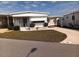 Charming single-story home featuring a covered carport and well-maintained lawn at 718 S Green Cir, Venice, FL 34285
