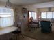 Inviting living room with a round table, comfortable seating, and window with sheer curtains at 718 S Green Cir, Venice, FL 34285