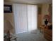 Bright living room with a large window and comfortable seating in a cozy home setting at 718 S Green Cir, Venice, FL 34285